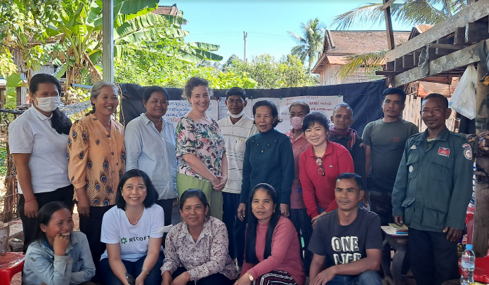 Community forestry chief and women’s network leader (center, black top), RISE project manager (bottom, white T-shirt), and RECOFTC country director (right, red top) surrounded by community forestry team members. Kampong Thom district, Cambodia.